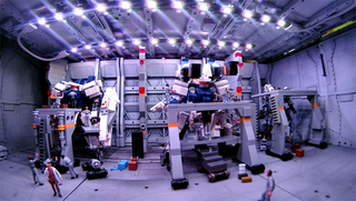 Illustration for article titled Model Hangars Look Much Better With Tiny Mecha Inside